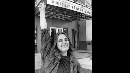 Judi Bari in front of a theater marquee.