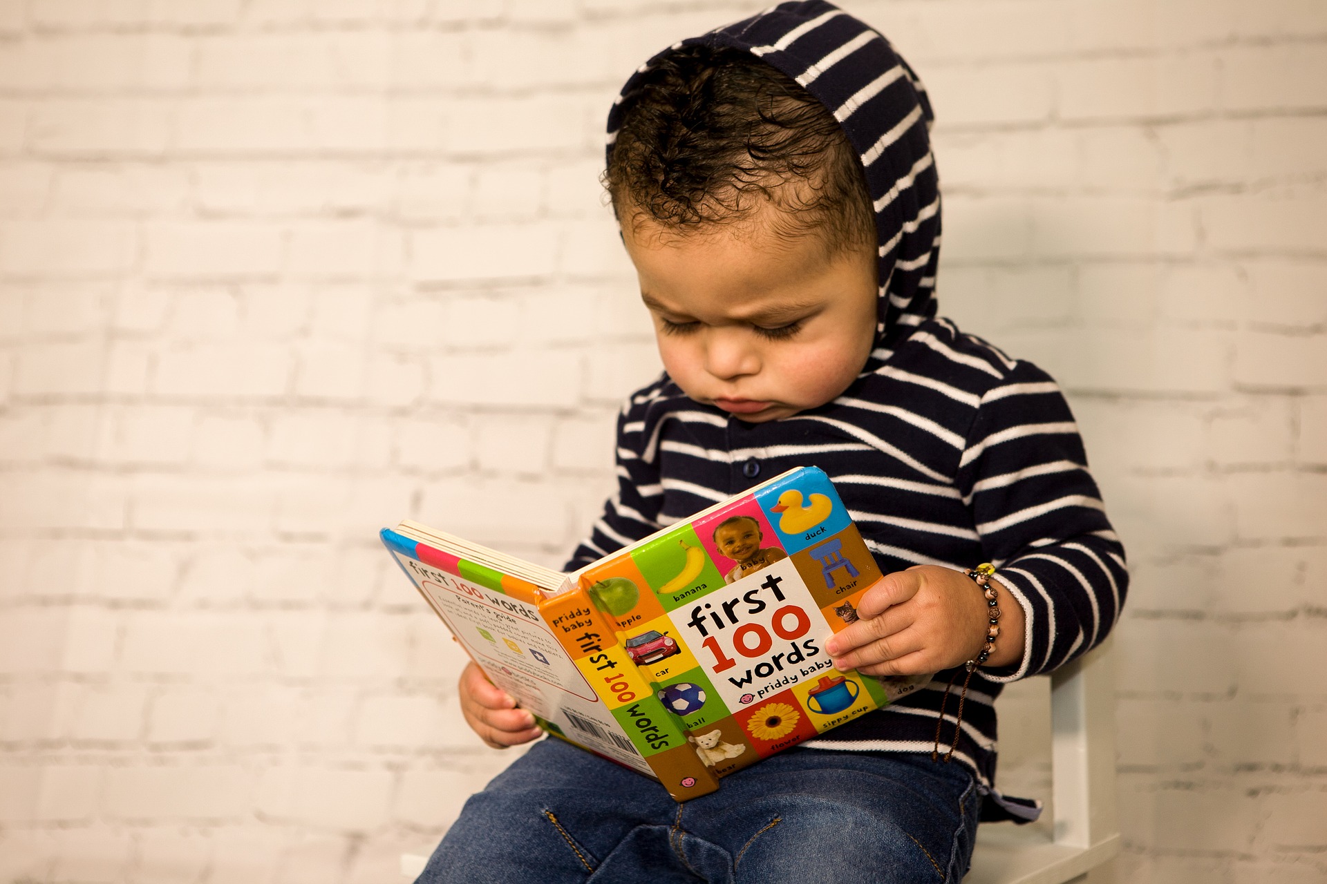 toddler reads a book of 100 first words