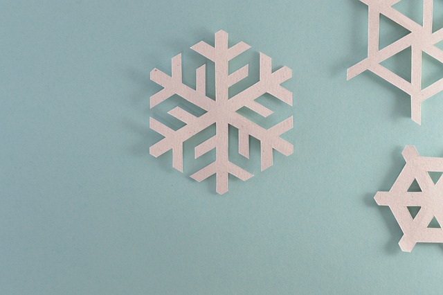 paper snowflakes on light blue background