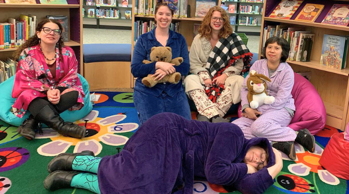 Pajama storytime with library staff in the kids room.
