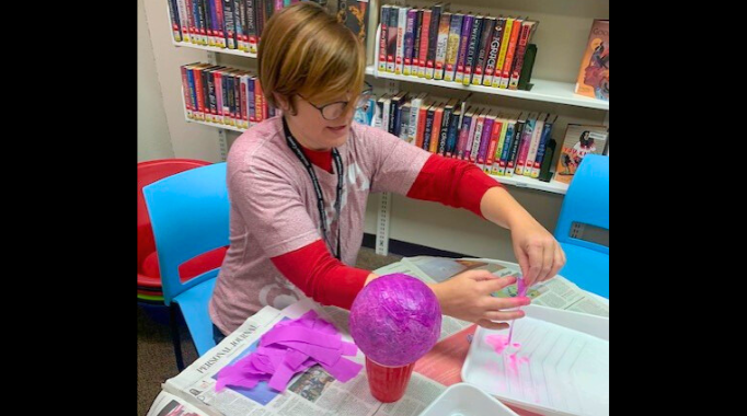 Librarian crafting with papier mache.