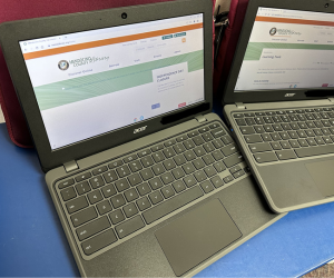 Two open Chromebook laptops.