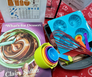 Cooking kit unpacked with recipe book and cooking tools.