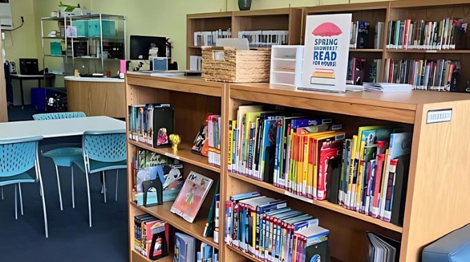 Bookshelves and table with front desk at the Laytonville Library.