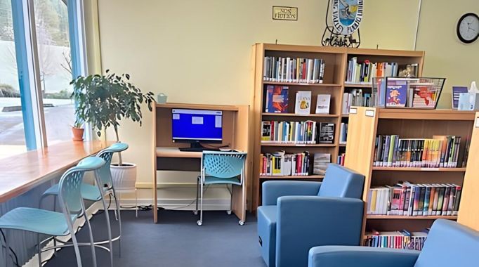 Bookshelves and chairs and public computer at the Laytonville Library.