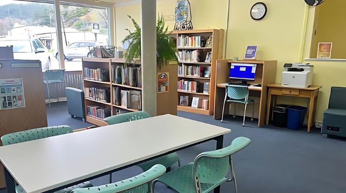 Bookshelves and chairs and public computer at the Laytonville library.