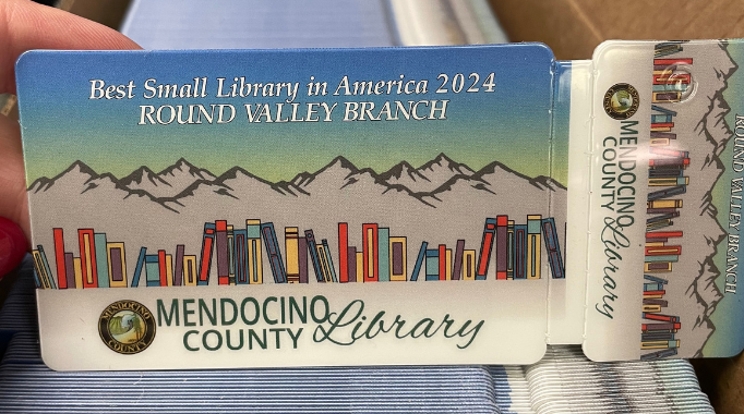 Round Valley Library card with graphic of mountains and books in honor of the Best Small Library in America.
