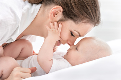 a photo of a woman rubbing her nose against her baby's nose